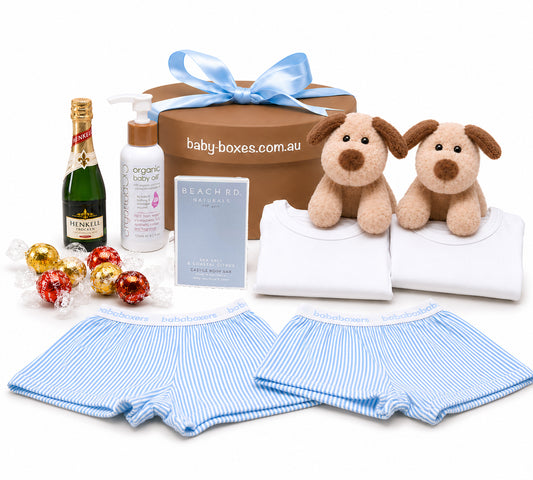 Baby gift set with toys for new baby twins and other items on a white background